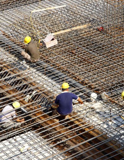 Construction workers installing rebar on a construction site.